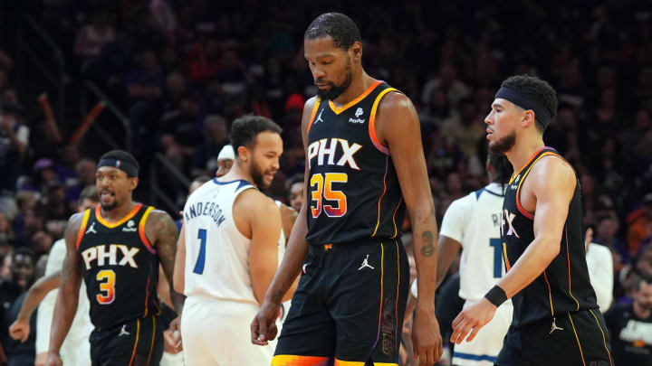 Apr 26, 2024; Phoenix, Arizona, USA; Phoenix Suns guard Bradley Beal (3) and Phoenix Suns forward Kevin Durant (35) and Phoenix Suns guard Devin Booker (1) react while Minnesota Timberwolves celebrate during the second half of game three of the first round for the 2024 NBA playoffs at Footprint Center. Mandatory Credit: Joe Camporeale-USA TODAY Sports