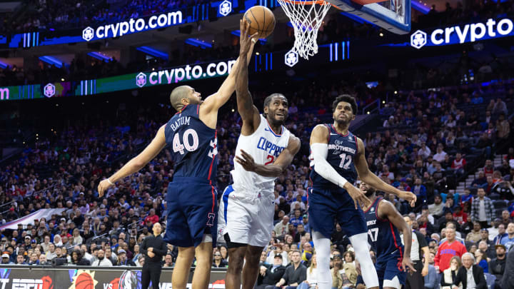 Mar 27, 2024; Philadelphia, Pennsylvania, USA; LA Clippers forward Kawhi Leonard (2) is fouled while driving for a score past Philadelphia 76ers forward Nicolas Batum (40) and forward Tobias Harris (12) to tie the game at 104 in the fourth quarter at Wells Fargo Center. Mandatory Credit: Bill Streicher-USA TODAY Sports