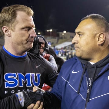 BYU coach Kalani Sitake (right) shakes the hand of SMU coach Rhett Lashlee after defeating the Mustangs at University Stadium Albuquerque.