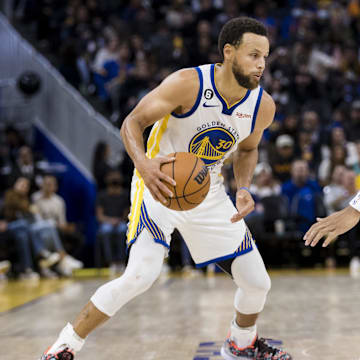 Oct 14, 2022; San Francisco, California, USA;  Golden State Warriors guard Stephen Curry (30) dribbles as Denver Nuggets forward Bruce Brown (11) defends during the second half at Chase Center. Mandatory Credit: John Hefti-Imagn Images