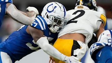 Indianapolis Colts linebacker Jaylon Carlies (57) wraps up Pittsburgh Steelers quarterback Justin Fields (2) on Sunday, Sept. 29, 2024, during a game against the Pittsburgh Steelers at Lucas Oil Stadium in Indianapolis.