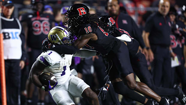 Washington Huskies running back Jonah Coleman (1) is tackled by Rutgers Scarlet Knights defensive back Flip Dixon (10)