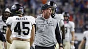Nov 8, 2025; Charlottesville, Virginia, USA; Wake Forest Demon Deacons head coach Jake Dickert (center) celebrates with players after blocking a touchdown pass in the final seconds of the second half against the Virginia Cavaliers at Scott Stadium. Mandatory Credit: Amber Searls-Imagn Images