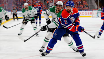 May 25, 2025; Edmonton, Alberta, CAN; Dallas Stars left wing Mason Marchment (27) and Edmonton Oilers defenseman Evan Bouchard (2) chase the puck during the second period in game three of the Western Conference Final of the 2025 Stanley Cup Playoffs at Rogers Place. Mandatory Credit: Perry Nelson-Imagn Images