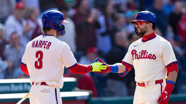 Apr 13, 2024; Philadelphia, Pennsylvania, USA; Philadelphia Phillies designated hitter Kyle Schwarber (12) celebrates with first base Bryce Harper (3) after hitting a home run during the first inning against the Pittsburgh Pirates at Citizens Bank Park.