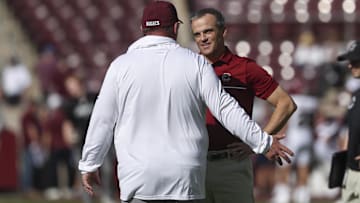Nov 15, 2025; College Station, Texas, USA; South Carolina Gamecocks head coach Shane Beamer talks with Texas A&M Aggies head coach Mike Elko before the game at Kyle Field. Mandatory Credit: Troy Taormina-Imagn Images