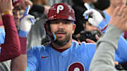 Oct 8, 2025; Los Angeles, California, USA; Philadelphia Phillies designated hitter Kyle Schwarber (12) congratulated in the dugout after hitting a solo home run in the fourth inning against the Los Angeles Dodgers of game three of the NLDS during the 2025 MLB playoffs at Dodger Stadium. Mandatory Credit: Jayne Kamin-Oncea-Imagn Images