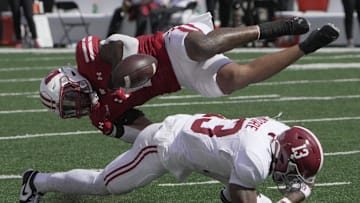 Sep 14, 2024; Madison, Wisconsin, USA; Wisconsin Bulldogs running back Chez Mellusi (1) fumbles the ball after being hit by Alabama Crimson Tide defensive back Malachi Moore (13) during the second quarter at Camp Randall Stadium. Alabama recovered the ball. Mandatory Credit: Mark Hoffman/USA TODAY Network via Imagn Images