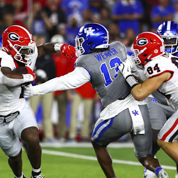 Sep 14, 2024; Lexington, Kentucky, USA; Georgia Bulldogs running back Trevor Etienne (1) is tackled by Kentucky Wildcats during the first quarter at Kroger Field. Mandatory Credit: Carter Skaggs-Imagn Images