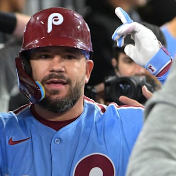 Oct 8, 2025; Los Angeles, California, USA; Philadelphia Phillies designated hitter Kyle Schwarber (12) congratulated in the dugout after hitting a solo home run in the fourth inning against the Los Angeles Dodgers of game three of the NLDS during the 2025 MLB playoffs at Dodger Stadium. 