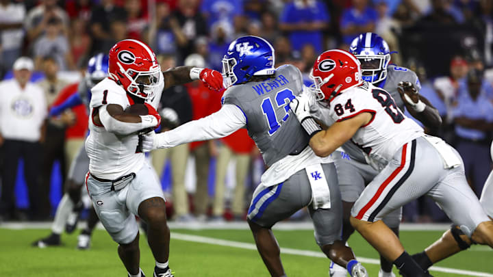 Sep 14, 2024; Lexington, Kentucky, USA; Georgia Bulldogs running back Trevor Etienne (1) is tackled by Kentucky Wildcats during the first quarter at Kroger Field. Mandatory Credit: Carter Skaggs-Imagn Images