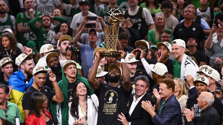 Jun 17, 2024; Boston, Massachusetts, USA; Boston Celtics guard Jaylen Brown (7) holds up the Larry O'Brien Championship Trophy after the Celtics beat the Dallas Mavericks in game five of the 2024 NBA Finals at the TD Garden. Mandatory Credit: Brian Fluharty-USA TODAY Sports