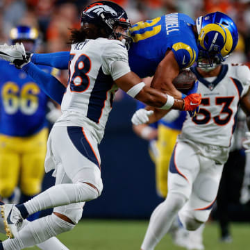 Aug 26, 2023; Denver, Colorado, USA; Los Angeles Rams wide receiver Austin Trammell (81) is upended by Denver Broncos safety JL Skinner (34) as safety Devon Key (38) defends in the third quarter at Empower Field at Mile High. Mandatory Credit: Isaiah J. Downing-USA TODAY Sports