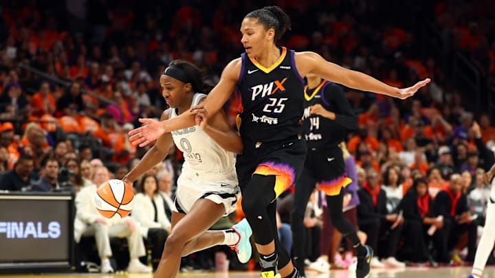 Oct 8, 2025; Phoenix, Arizona, USA; Las Vegas Aces guard Jackie Young (0) controls the ball against Phoenix Mercury forward Alyssa Thomas (25) in the first half during game three of the 2025 WNBA Finals at PHX Arena. Mandatory Credit: Mark J. Rebilas-Imagn Images