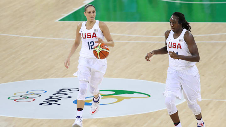 Aug 7, 2016; Rio de Janeiro, Brazil; United States guard Diana Taurasi (12) brings the ball up court with center Tina Charles (14) against Senegal during the Rio 2016 Summer Olympic Games at Youth Arena. Mandatory Credit: Geoff Burke-Imagn Images