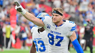 Sep 22, 2024; Glendale, Arizona, USA;  Detroit Lions defensive end Aidan Hutchinson (97) and defensive end Josh Paschal (93) celebrate after stopping the Arizona Cardinals on 4th and 1 in the second half at State Farm Stadium.