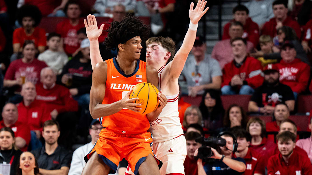 Jan 30, 2025; Lincoln, Nebraska, USA; Illinois Fighting Illini forward Carey Booth (0) controls the ball against Nebraska Cornhuskers guard Connor Essegian (0) during the first half at Pinnacle Bank Arena. Mandatory Credit: Dylan Widger-Imagn Images