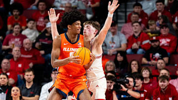 Jan 30, 2025; Lincoln, Nebraska, USA; Illinois Fighting Illini forward Carey Booth (0) controls the ball against Nebraska Cornhuskers guard Connor Essegian (0) during the first half at Pinnacle Bank Arena. Mandatory Credit: Dylan Widger-Imagn Images