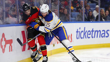 Buffalo Sabres defenseman Owen Power (25) checks Ottawa Senators defenseman Artem Zub (2) as he goes for a loose puck during the first period Oct 15, 2025; Buffalo, New York, USA;  at KeyBank Center. Mandatory Credit: Timothy T. Ludwig-Imagn Images