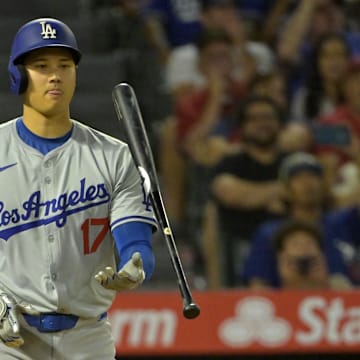 Sep 3, 2024; Anaheim, California, USA;  Los Angeles Dodgers designated hitter Shohei Ohtani (17) flips his bat as he is given an intentional walk in the tenth nning against the Los Angeles Angels at Angel Stadium. Mandatory Credit: Jayne Kamin-Oncea-Imagn Images