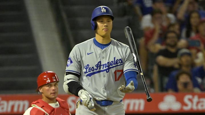 Sep 3, 2024; Anaheim, California, USA;  Los Angeles Dodgers designated hitter Shohei Ohtani (17) flips his bat as he is given an intentional walk in the tenth nning against the Los Angeles Angels at Angel Stadium. Mandatory Credit: Jayne Kamin-Oncea-Imagn Images