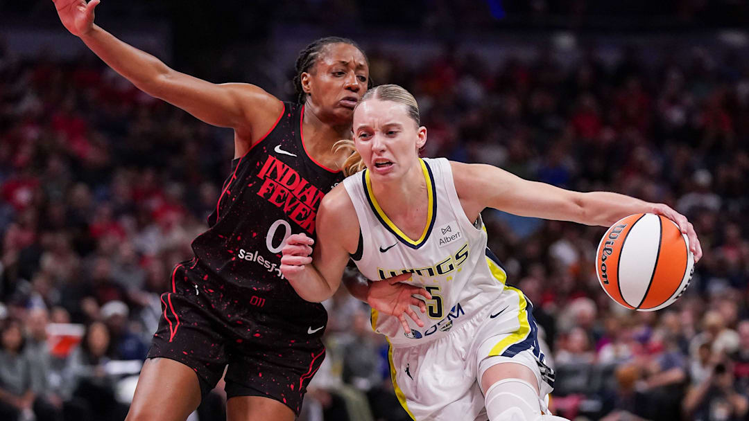 Indiana Fever guard Kelsey Mitchell (0) rushes up the court against Dallas Wings guard Paige Bueckers (5) on Tuesday, Aug. 12, 2025, during the game at Gainbridge Fieldhouse in Indianapolis. The Dallas Wings defeated the Indiana Fever, 81-80.