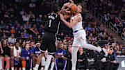 Nov 9, 2025; New York, New York, USA;  Brooklyn Nets forward Ziaire Williams (1) and New York Knicks forward Pacome Dadiet (4) fight for a loose ball in the fourth quarter at Madison Square Garden. Mandatory Credit: Wendell Cruz-Imagn Images