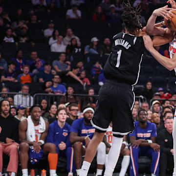 Nov 9, 2025; New York, New York, USA;  Brooklyn Nets forward Ziaire Williams (1) and New York Knicks forward Pacome Dadiet (4) fight for a loose ball in the fourth quarter at Madison Square Garden. Mandatory Credit: Wendell Cruz-Imagn Images