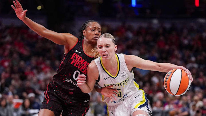 Indiana Fever guard Kelsey Mitchell (0) rushes up the court against Dallas Wings guard Paige Bueckers (5) on Tuesday, Aug. 12, 2025, during the game at Gainbridge Fieldhouse in Indianapolis. The Dallas Wings defeated the Indiana Fever, 81-80.