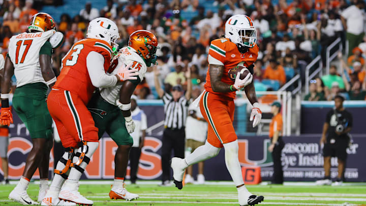 Sep 7, 2024; Miami Gardens, Florida, USA; Miami Hurricanes running back Mark Fletcher Jr. (4) scores a touchdown against the Florida A&M Rattlers during the third quarter at Hard Rock Stadium. Mandatory Credit: Sam Navarro-Imagn Images