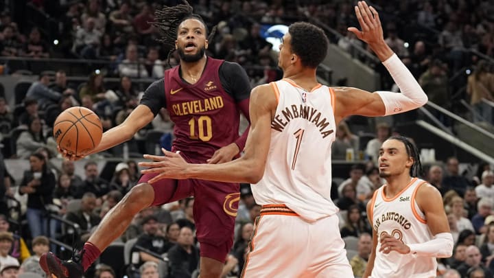 Feb 3, 2024; San Antonio, Texas, USA; Cleveland Cavaliers guard Darius Garland (10) passes the ball around San Antonio Spurs forward Victor Wembanyama (1) during the second half at Frost Bank Center. Mandatory Credit: Scott Wachter-USA TODAY Sports