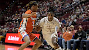 Jan 4, 2025; Tallahassee, Florida, USA; Florida State Seminoles forward Jamir Watkins (1) drives the ball to the net against Syracuse Orange guard Lucas Taylor (3) during the first half at Donald L. Tucker Center. Mandatory Credit: Melina Myers-Imagn Images