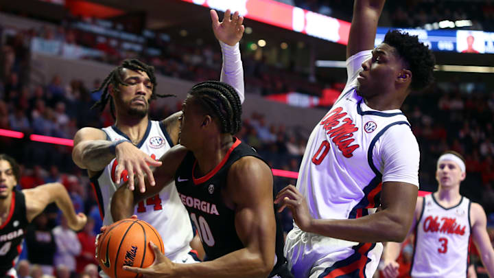 Jan 4, 2025; Oxford, Mississippi, USA; Georgia Bulldogs forward RJ Godfrey (10) drives to the basket as Mississippi Rebels guard Dre Davis (14) and Mississippi Rebels forward Malik Dia (0) defends during the first half at The Sandy and John Black Pavilion at Ole Miss. Mandatory Credit: Petre Thomas-Imagn Images Jan 4, 2025; Oxford, Mississippi, USA; Georgia Bulldogs forward RJ Godfrey (10) drives to the basket as Mississippi Rebels guard Dre Davis (14) and Mississippi Rebels forward Malik Dia (0) defends during the first half at The Sandy and John Black Pavilion at Ole Miss. Mandatory Credit: Petre Thomas-Imagn Images
