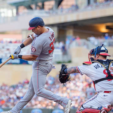 Jul 26, 2025; Minneapolis, Minnesota, USA; Washington Nationals first baseman Nathaniel Lowe (33) connects with the ball in the first inning. Minnesota Twins shortstop Carlos Correa (4) would field the ball and throw him out at first at Target Field. Mandatory Credit: Matt Blewett-Imagn Images