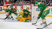 Jan 25, 2025; Saint Paul, Minnesota, USA; Minnesota Wild defenseman Brock Faber (7) plays the puck in front of goaltender Marc-Andre Fleury (29) against the Calgary Flames in the third period at Xcel Energy Center. Mandatory Credit: Matt Blewett-Imagn Images