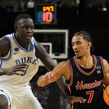 Apr 5, 2025; San Antonio, TX, USA; Houston Cougars guard Milos Uzan (7) dribbles the ball against Duke Blue Devils center Khaman Maluach (9) during the first half in the semifinals of the men's Final Four of the 2025 NCAA Tournament at the Alamodome. Mandatory Credit: Bob Donnan-Imagn Images
