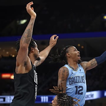 Dec 13, 2024; Memphis, Tennessee, USA; Memphis Grizzlies guard Ja Morant (12) drives to the basket during the fourth quarter against the Brooklyn Nets at FedExForum. Mandatory Credit: Petre Thomas-Imagn Images