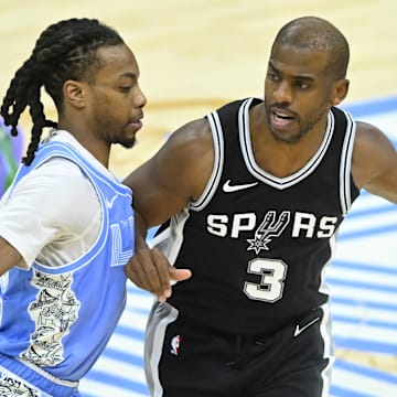 Mar 27, 2025; Cleveland, Ohio, USA; San Antonio Spurs guard Chris Paul (3) dribbles beside Cleveland Cavaliers guard Darius Garland (10) in the fourth quarter at Rocket Arena. Mandatory Credit: David Richard-Imagn Images