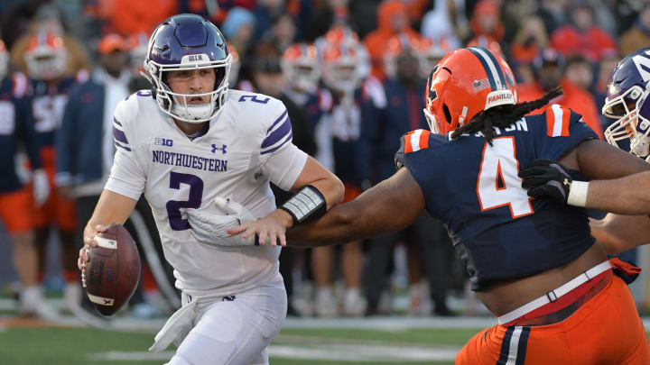 Nov 25, 2023; Champaign, Illinois, USA; Illinois Fighting Illini defensive tackle Jer'Zhan Newton (4) sacks Northwestern Wildcats quarterback Ben Bryant (2) during the first half at Memorial Stadium. Mandatory Credit: Ron Johnson-USA TODAY Sports