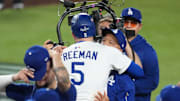 Oct 27, 2025; Los Angeles, California, USA; Los Angeles Dodgers first baseman Freddie Freeman (5) celebrates with manager Dave Roberts (30) after hitting a walk off home run in the eighteenth inning against the Toronto Blue Jays during game three of the 2025 MLB World Series at Dodger Stadium. Mandatory Credit: Kirby Lee-Imagn Images