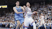Oklahoma City Thunder center Isaiah Hartenstein (55) drives to the basket in front of Memphis Grizzlies center Zach Edey (14)