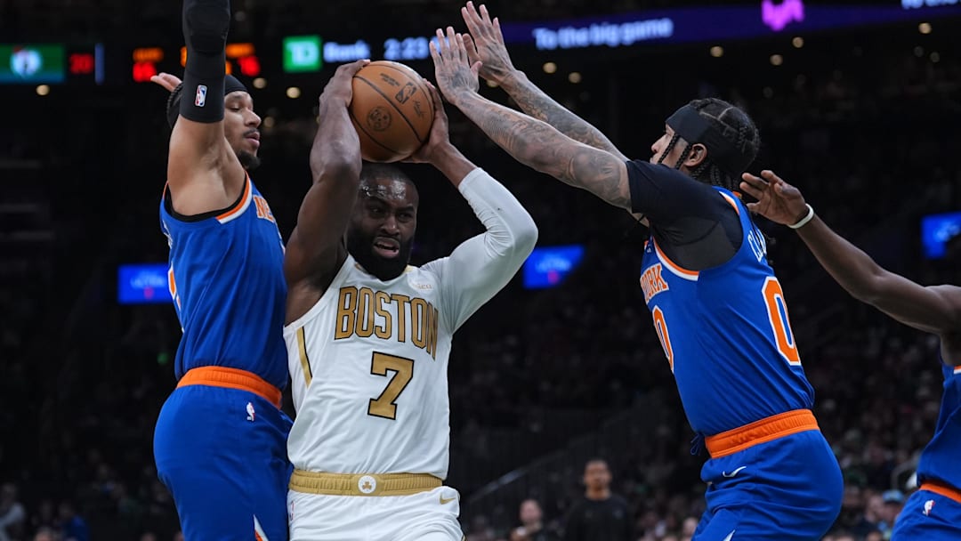 Feb 8, 2026; Boston, Massachusetts, USA; New York Knicks guard Jordan Clarkson (00) and guard Josh Hart (3) defend against Boston Celtics guard Jaylen Brown (7) in the second half at TD Garden.
