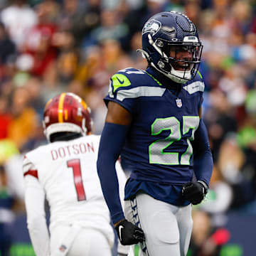 Nov 12, 2023; Seattle, Washington, USA; Seattle Seahawks cornerback Riq Woolen (27) reacts after a pass defense against the Washington Commanders during the second quarter at Lumen Field. Mandatory Credit: Joe Nicholson-USA TODAY Sports