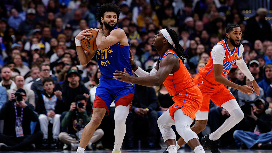 Feb 1, 2026; Denver, Colorado, USA; Denver Nuggets guard Jamal Murray (27) controls the ball as Oklahoma City Thunder guard Luguentz Dort (5) guards in the second quarter at Ball Arena.