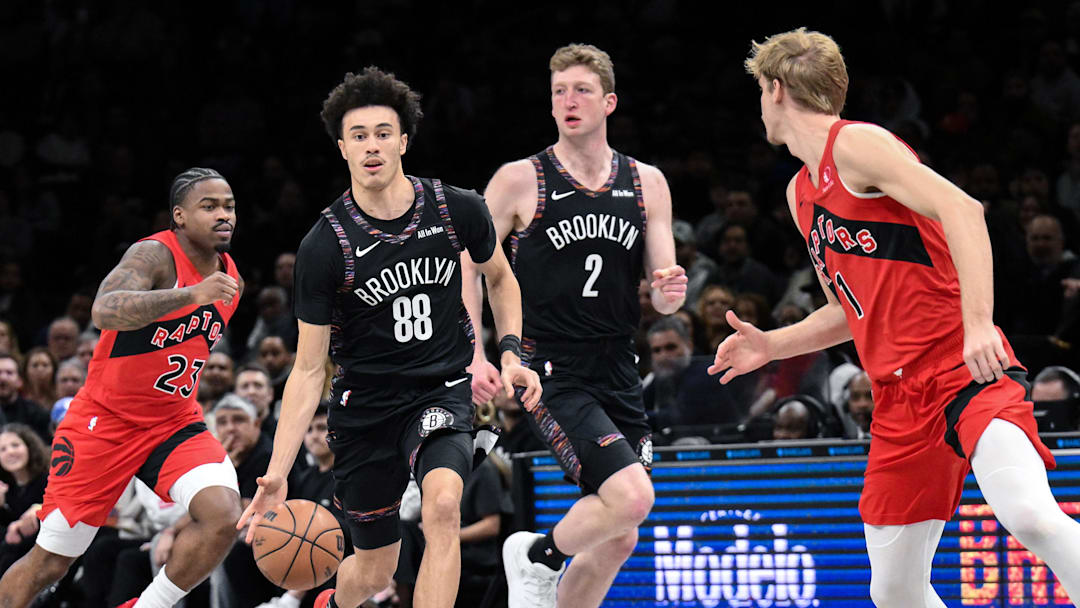 Dec 21, 2025; Brooklyn, New York, USA; Brooklyn Nets guard Nolan Traore (88) brings the ball up court while defended by Toronto Raptors guard/forward Gradey Dick (1) during the first half at Barclays Center. Mandatory Credit: John Jones-Imagn Images
