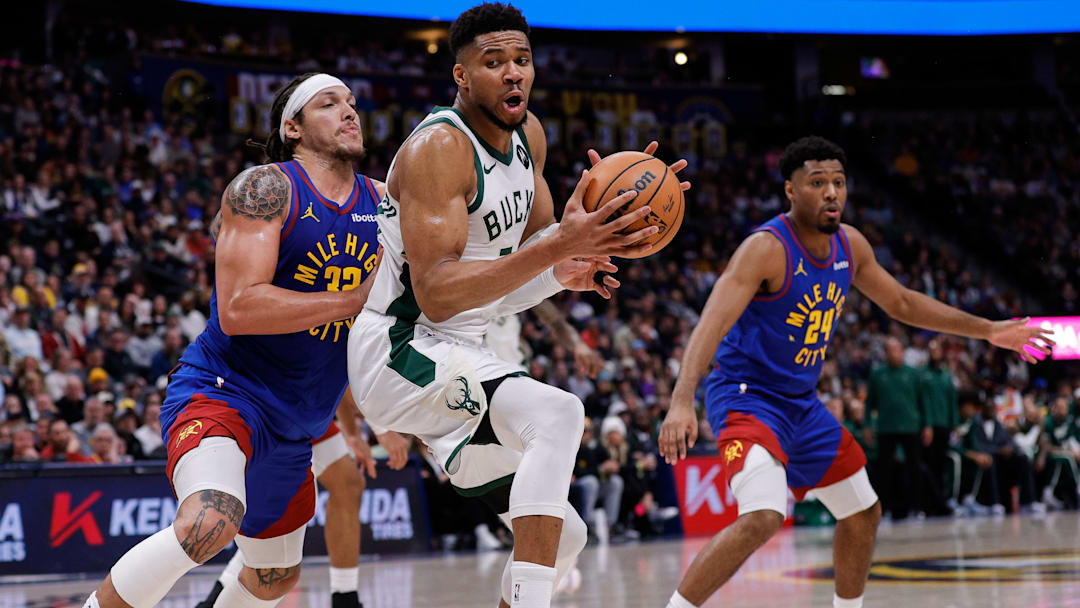 Jan 11, 2026; Denver, Colorado, USA; Milwaukee Bucks forward Giannis Antetokounmpo (34) controls the ball under pressure from Denver Nuggets forward Aaron Gordon (32) in the fourth quarter at Ball Arena. Mandatory Credit: Isaiah J. Downing-Imagn Images