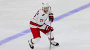 Sep 29, 2023; Sunrise, Florida, USA; Carolina Hurricanes defenseman Tony DeAngelo (77) moves the puck against the Florida Panthers during the third period at Amerant Bank Arena. Mandatory Credit: Sam Navarro-Imagn Images