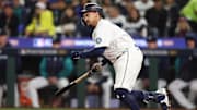 Oct 16, 2025; Seattle, Washington, USA; Seattle Mariners first baseman Josh Naylor (12) singles in the fifth inning against the Toronto Blue Jays during game four of the ALCS round for the 2025 MLB playoffs at T-Mobile Park. Mandatory Credit: Kevin Ng-Imagn Images