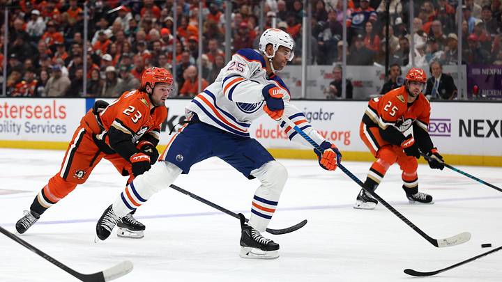 Apr 24, 2026; Anaheim, California, USA;  Edmonton Oilers defenseman Darnell Nurse (25) shoots the puck ahead of Anaheim Ducks center Mason McTavish (23) during the first period of game three of the first round of the 2026 Stanley Cup Playoffs at Honda Center. Mandatory Credit: Kiyoshi Mio-Imagn Images