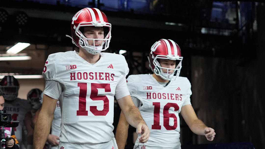 Dec 6, 2025; Indianapolis, IN, USA; Indiana Hoosiers quarterback Fernando Mendoza (15) and quarterback Alberto Mendoza (16) walk on field for warm ups before the 2025 Big Ten championship game against the Ohio State Buckeyes at Lucas Oil Stadium.